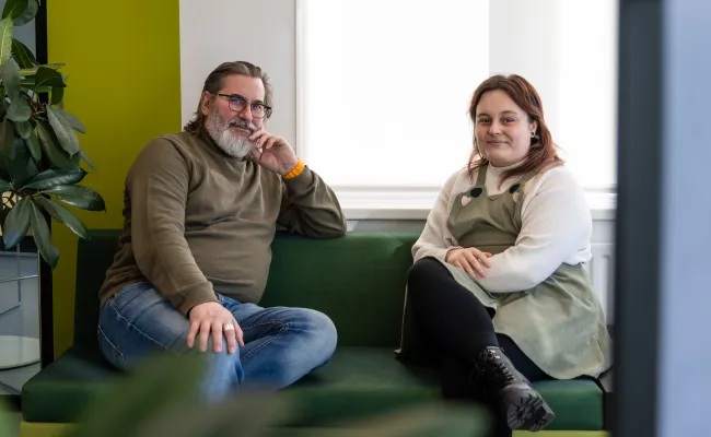 Leidinggevende Henk en service center consulent Sam zitten langs elkaar