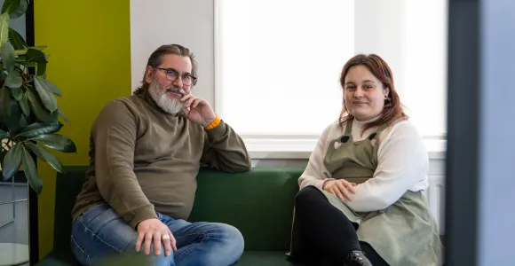 Leidinggevende Henk en service center consulent Sam zitten langs elkaar