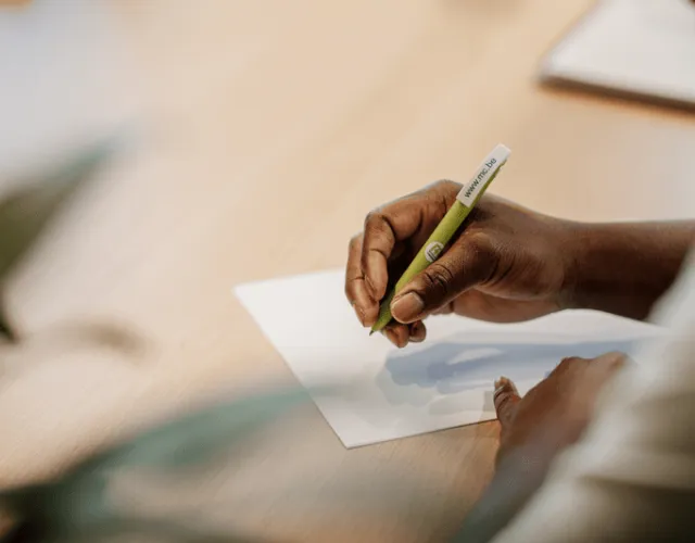 Someone using a pen with CM inscription